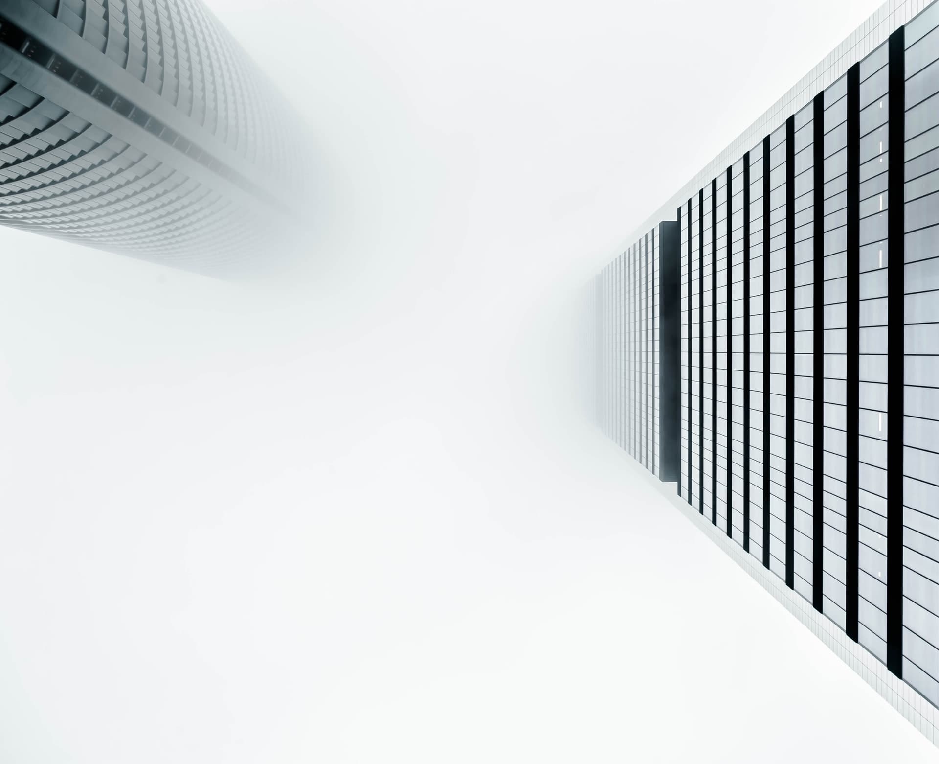 Skyscrapers in a black and white background get lost in the fog. Located in Madrid.